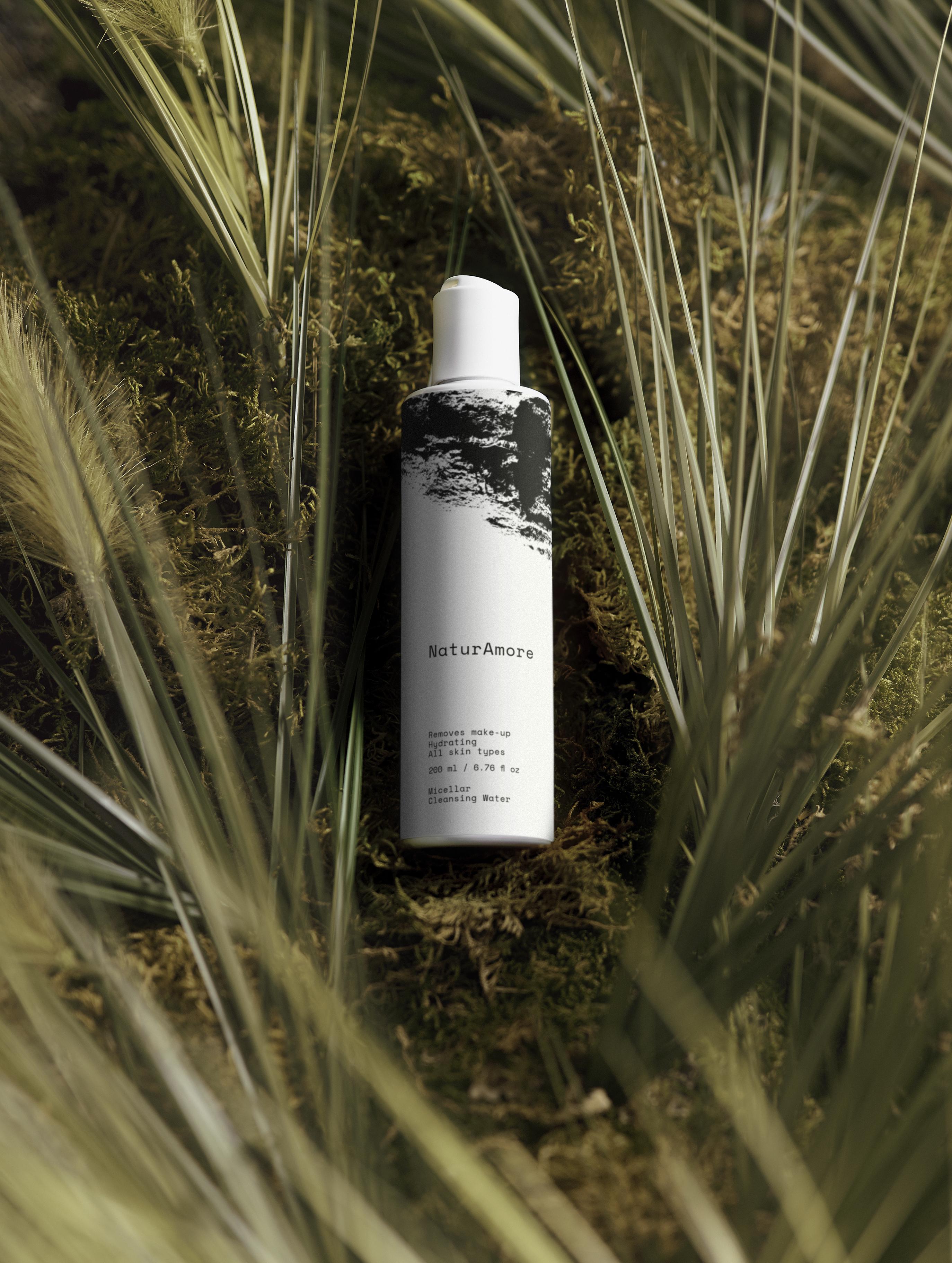 NaturAmore 200ml Hydrating Micellar Cleansing Water with Hyaluronic Acid in a minimalist white bottle with black graphics.